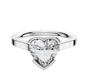 A 14K white gold bezel half bezel east/west cathedral flat 2.0mm engagement ring with a large heart-shaped clear diamond centerpiece, features a polished band and is displayed against a plain white background.