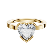 An 18K yellow gold Bezel Half Bezel East/West Classic Flat 2.0mm engagement ring is showcased as the centerpiece, set against a plain white background.