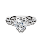 A 14K white gold engagement ring featuring a knife-edge band with an east/west bezel-set center stone and a single row of pave diamonds along the cathedral setting.