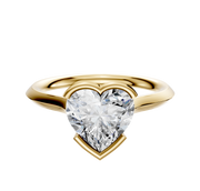 An 18K yellow gold bezel half bezel east/west cathedral knife edge 2.0mm engagement ring is displayed against a plain white background.