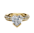 A 14K yellow gold classic knife-edge engagement ring featuring a 2.5mm center stone in an east/west bezel setting, accented by one row of pavé diamonds along the band.