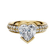 A 14K yellow gold classic knife-edge engagement ring featuring a 2.5mm center stone in an east/west bezel setting, accented by one row of pavé diamonds along the band.