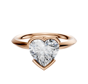 A 14K rose gold bezel half bezel east/west classic knife edge 2.0mm engagement ring is shown, featuring a large heart-shaped diamond at the center against a plain white background.
