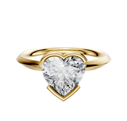An 18K yellow gold bezel half bezel east/west classic knife edge 2.0mm engagement ring is displayed against a plain white background.