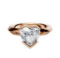 A 14K rose gold engagement ring with a classic knife edge and half bezel east/west setting, shown on a plain white background.