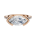 The 14K Rose Gold Bezel Half Bezel East/West Cathedral Dome 1-Row-Pave 2.5mm Engagement Ring showcases a unique east/west set center stone in a bezel and half bezel setting, accented by a single row of pave-set diamonds along the band.
