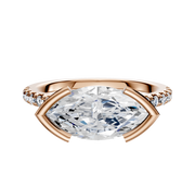 The 14K Rose Gold Bezel Half Bezel East/West Cathedral Dome 1-Row-Pave 2.5mm Engagement Ring showcases a unique east/west set center stone in a bezel and half bezel setting, accented by a single row of pave-set diamonds along the band.