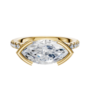 The 18K Yellow Gold Bezel Half Bezel East/West Cathedral Dome Engagement Ring features a large center diamond held in an east-west setting, accented by a row of pave diamonds along the 2.5mm band, shown against a white background.