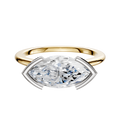 A 14K two-tone bezel half-bezel east/west cathedral dome 1.5mm engagement ring featuring a modern, minimalist design with a marquise-cut diamond set horizontally.