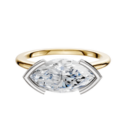 A 14K two-tone bezel half-bezel east/west cathedral dome 1.5mm engagement ring featuring a modern, minimalist design with a marquise-cut diamond set horizontally.