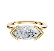 An 18K yellow gold Bezel Half Bezel East/West Cathedral Dome 1.5mm engagement ring with a large marquise-cut clear gemstone set horizontally and secured by curved gold prongs, shown on a plain white background.