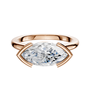 The 18K Rose Gold Bezel Half Bezel East/West Cathedral Dome 2.0mm Engagement Ring features a large marquise-cut diamond set horizontally with curved prongs, displayed on a white background.