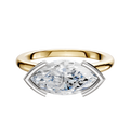 The 18K Two Tone Bezel Half Bezel East/West Cathedral Dome 2.0mm Engagement Ring features a modern marquise diamond set horizontally in a sleek, contemporary setting with gold and white metal tones.