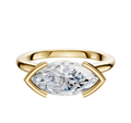 An 18K yellow gold bezel half bezel east/west cathedral dome engagement ring with a 2.0mm band, featuring a modern, horizontally set design.