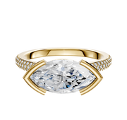 The 18K Yellow Gold Bezel Half Bezel East/West Cathedral Dome Engagement Ring features a central stone with three rows of 2.0mm pave-set diamonds along the band for added brilliance.