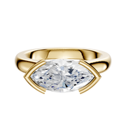 The 18K Yellow Gold Bezel Half Bezel East/West Cathedral Dome 3.0mm Engagement Ring features a horizontally set marquise-cut clear diamond with two gold prongs on each end, shown against a plain white background.