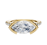 The 14K Yellow Gold Bezel Half Bezel East/West Classic Dome 1-Row-Pave 2.5mm Engagement Ring features a horizontally set marquise diamond and a band adorned with small round diamonds, displayed on a white background.