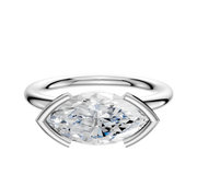 A 14K white gold bezel half bezel engagement ring with a classic dome 2.0mm band, featuring an east/west set center stone, displayed against a plain white background.