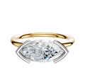A 14K two tone Bezel Half Bezel East/West Classic Dome 2.0mm engagement ring is showcased, featuring a marquise-shaped diamond in a white metal four-prong setting, displayed on a plain white background.