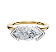 A 14K two tone Bezel Half Bezel East/West Classic Dome 2.0mm engagement ring is showcased, featuring a marquise-shaped diamond in a white metal four-prong setting, displayed on a plain white background.