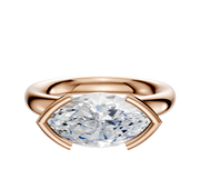 The 14K Rose Gold Bezel Half Bezel East/West Classic Dome 3.0mm Engagement Ring showcases a large, horizontally set marquise-cut diamond in a modern partial bezel on a plain white background.