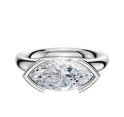 A 14K white gold engagement ring showcases a classic dome design with a 3.0mm marquise-cut diamond set in an east/west half bezel on a minimalist band, displayed against a plain white background.