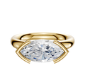 A 14K yellow gold engagement ring with a classic dome and a 3.0mm marquise-cut diamond set east/west in a modern half bezel, shown against a plain white background.