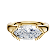 An 18K yellow gold Bezel Half Bezel East/West Classic Dome 4.0mm engagement ring with a horizontally set marquise-cut diamond and four unique gold prongs, displayed on a polished gold band against a white background.