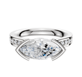 A 14K two-tone engagement ring with a flat band features an east/west cathedral setting and half bezel, adorned with a 1-row pave of small diamonds.