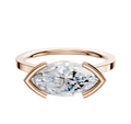 A 14K rose gold bezel half bezel east/west cathedral flat 1.5mm engagement ring is shown with a horizontally set marquise-cut diamond on a plain white background.
