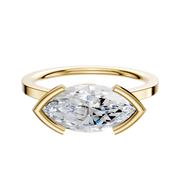 An 18K yellow gold Bezel Half Bezel East/West Cathedral Flat 1.5mm engagement ring with a marquise-cut diamond, shown on a plain white background.