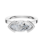 A 14K white gold bezel half bezel East/West cathedral flat 2.0mm engagement ring displays a large marquise-cut diamond set horizontally with minimalist prongs, shown against a plain white background.