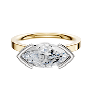 A modern 18K two-tone bezel half bezel East/West cathedral flat 2.0mm engagement ring, featuring a marquise-cut diamond in a minimalist silver prong setting, displayed on a plain white background.