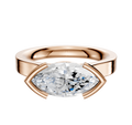 The 18K Rose Gold Bezel Half Bezel East/West Cathedral Flat 3.0mm Engagement Ring features a horizontally set marquise diamond with modern prongs on a polished band, displayed against a white background.