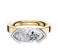 The 14K Two Tone Bezel Half Bezel East/West Cathedral Flat 3.0mm Engagement Ring is showcased against a plain white background, featuring a sleek design that highlights its distinctive setting.