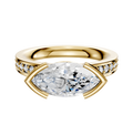 An 18K yellow gold Bezel Half Bezel East/West Classic Flat 1-Row-Pave 2.5mm engagement ring, featuring a marquise-cut diamond center and round pave diamonds along the band, displayed on a plain white background.
