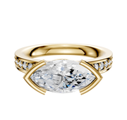 An 18K yellow gold Bezel Half Bezel East/West Classic Flat 1-Row-Pave 2.5mm engagement ring, featuring a marquise-cut diamond center and round pave diamonds along the band, displayed on a plain white background.
