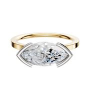 The 14K Two Tone Bezel Half Bezel East/West Classic Flat 1.5mm Engagement Ring features a modern marquise diamond in a geometric setting, displayed against a plain white background.