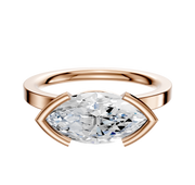The 18K Rose Gold Bezel Half Bezel East/West Classic Flat 2.0mm Engagement Ring features a bold, marquise-cut clear gemstone secured in a four-prong setting, displayed against a plain white background.