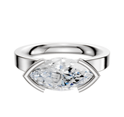 An 18K white gold bezel half bezel East/West classic flat 3.0mm engagement ring featuring a horizontally set marquise-cut clear gemstone in a minimalist setting, displayed against a plain white background.