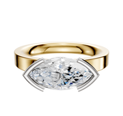 An 18K two-tone bezel half-bezel East/West Classic Flat 3.0mm engagement ring is displayed with a modern design, featuring both gold and silver tones against a plain white background.