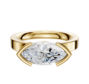A 14K yellow gold Bezel Half Bezel East/West Classic Flat 3.0mm Engagement Ring is shown, featuring a horizontally set marquise-cut diamond against a plain white background.