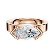 The 14K Rose Gold Bezel Half Bezel East/West Classic Flat 4.0mm Engagement Ring features a large marquise-cut white diamond set horizontally in a modern, open bezel setting on a wide rose gold band.