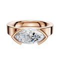 The 18K Rose Gold Bezel Half Bezel East/West Classic Flat 4.0mm Engagement Ring showcases a large, horizontally-set marquise-cut clear gemstone in a sleek, modern bezel setting against a white background.