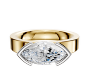 The 18K Two Tone Bezel Half Bezel East/West Classic Flat 4.0mm Engagement Ring showcases a striking marquise-cut diamond set horizontally in a modern bezel setting on a wide, elegant band.