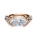The 14K Rose Gold Bezel Half Bezel East/West Cathedral Knife Edge 1-Row-Pave 2.5mm Engagement Ring features a striking marquise-cut center diamond with a row of round pave diamonds on each side, displayed against a light background.