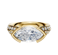 The 18K Yellow Gold Bezel Half Bezel East/West Cathedral Knife Edge 1-Row-Pave 2.5mm Engagement Ring showcases a central marquise diamond and round pave diamonds along a split band, presented on a simple light background.
