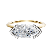 The 14K Two Tone Bezel Half Bezel East/West Cathedral Knife Edge 1.5mm Engagement Ring features an elegant design with a distinctive setting, showcased on a white background.