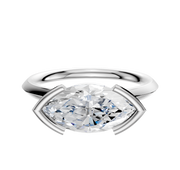The 14K White Gold Bezel Half Bezel East/West Cathedral Knife Edge 2.0mm Engagement Ring showcases a marquise-cut clear diamond in a unique east-west bezel setting with angular prongs, displayed on a plain white background.
