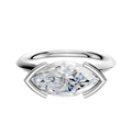 An 18K white gold bezel half-bezel east/west cathedral knife edge 2.0mm engagement ring with a modern, minimalist setting is displayed against a plain white background.